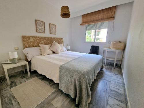 a bedroom with a large bed and a window at Marbella - Puerto Banus in Marbella
