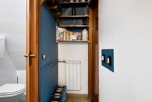 a bathroom with a toilet and a blue door at Ca Du Grifun - Vernazza in Vernazza