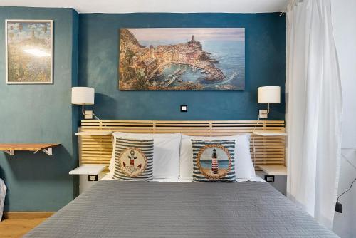 a bedroom with a bed with a painting on the wall at Ca Du Grifun - Vernazza in Vernazza
