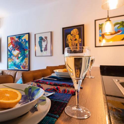 a table with a glass of wine on top of it at Casa de Arte in Dorp Sint Michiel
