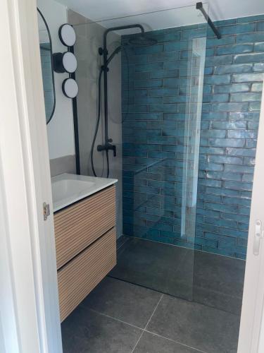 a bathroom with a shower with a sink and a tub at Casa Hegoa in Elgóibar