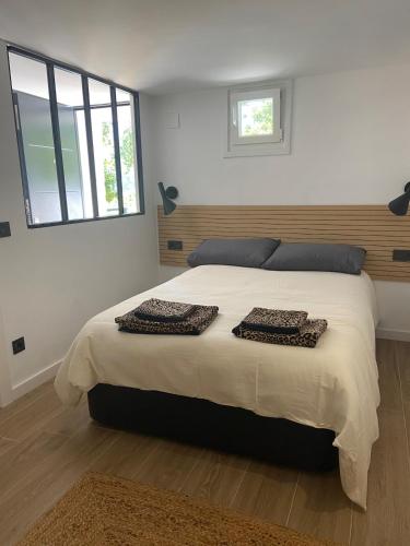 a bedroom with a large bed with two pillows on it at Casa Hegoa in Elgóibar