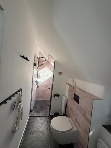 a white bathroom with a toilet and a shower at BAN 01A in Gremersdorf