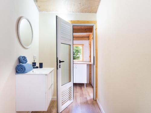 a bathroom with a mirror and a white sink at Live Villa Adrian in Caleta de Interián