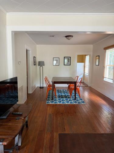 a living room with a wooden table and chairs at Blue Moon Guest House in Lafayette