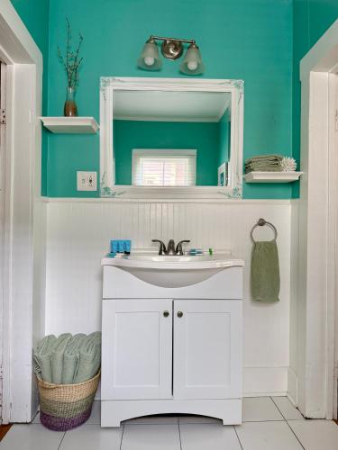 a bathroom with a white sink and a mirror at Blue Moon Guest House in Lafayette