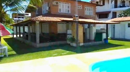 a house with a pool in front of it at Wind Villa Cumbuco - Casa in Cumbuco