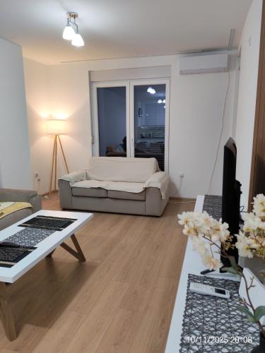 a living room with a bed and a table at Milenov Beli Kamen in Prokuplje