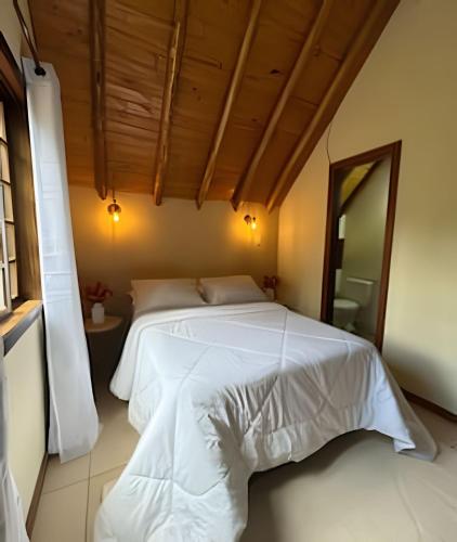 En eller flere senge i et værelse på Chalé Vermont | Privacidade & Sofisticação