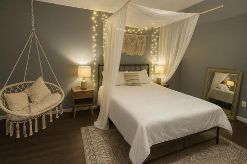 a bedroom with a canopy bed and a chair at Wildlife with style in the mountains in Stanley