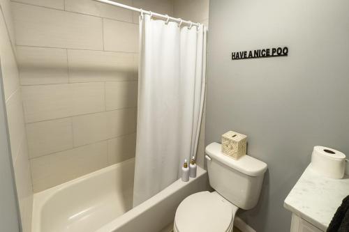 a white bathroom with a toilet and a shower at Wildlife with style in the mountains in Stanley
