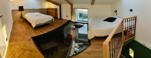 a room with two beds and a balcony at Gîte du Volcan des Causses in Saint-Jean-dʼAlcapiès