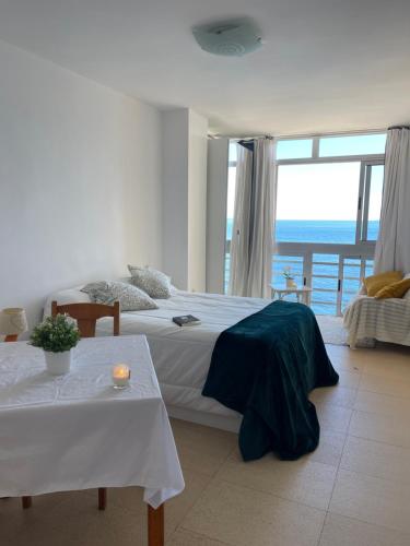 a bedroom with a bed with a view of the ocean at &luxe vista mar& in Calpe