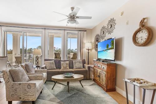 a living room with a couch and a tv at Observation Point North 456 in Destin