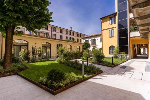 an exterior view of a building with a courtyard at Agnesi Statue in Milan