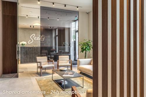 a lobby with a waiting area with chairs and a table at Agnesi Statue in Milan