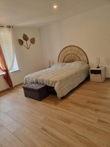 a bedroom with a large bed and a wooden floor at Chez Remi in Esmoulières