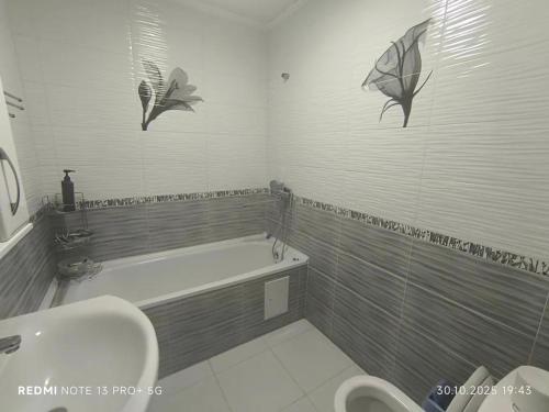 a bathroom with a bath tub and a sink at Екохостел in Bishkek