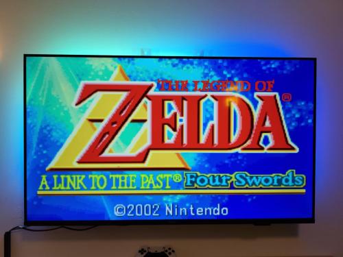 a television screen with a legend of zelda sign at Lunaria Living I Studio - Ambilight 55 Zoll TV - Retro-Konsole -Parkplatz - Zentral - HBF-nah & VW-Tor 17 in Wolfsburg