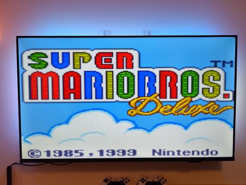 a television screen with a super mariods game on it at Lunaria Living I Studio - Ambilight 55 Zoll TV - Retro-Konsole -Parkplatz - Zentral - HBF-nah & VW-Tor 17 in Wolfsburg
