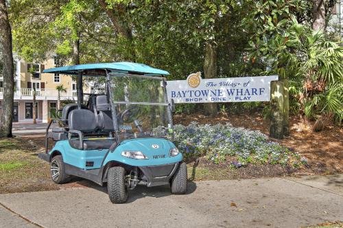 a blue golf cart parked in front of a sign at Pilot House 413 in Destin
