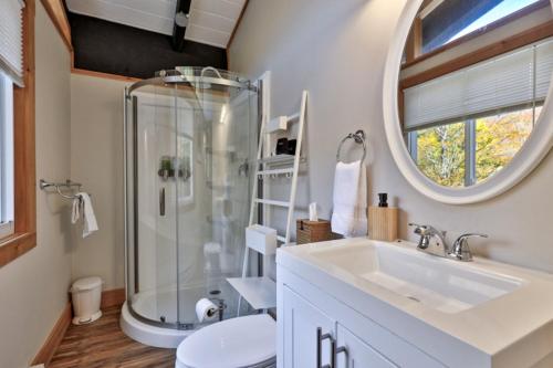 a bathroom with a shower and a sink at RoundTop Chalet - Hot Tub, Fire Pit & Mountain Views near Killington & Okemo in Plymouth