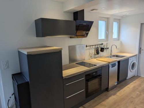 a kitchen with a sink and a stove at Cozy apartment with terrace in Crach