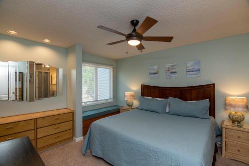 a bedroom with a bed and a ceiling fan at 493 Egrets Pointe - Dove's Nest in Edisto Island