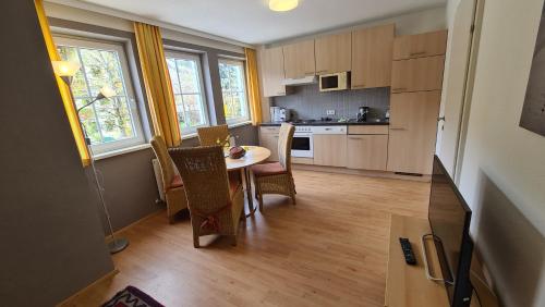 a kitchen with a table and chairs in a room at Dependance I in Schladming