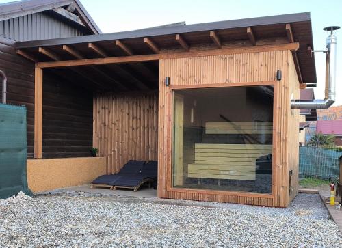 a wooden pavilion with a bench inside of it at Ubytovanie u Petra in Čadca