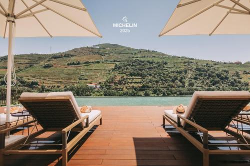 a row of chairs and umbrellas on a patio at Torel Quinta da Vacaria - Douro Valley in Peso da Régua