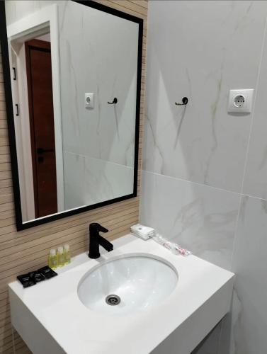 a bathroom with a white sink and a mirror at Or Haganuz in Dobrovelychkivka