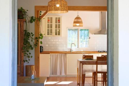 a kitchen with a sink and a table in a room at Casa Rural El Membrillo by SIERRA VIVA in Jabuguillo
