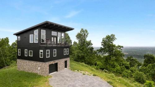 a black house on top of a hill at Scenic Getaway Cabin w/ Fire Pit, Deck & Panoramic Views in Martinsburg, WV in Martinsburg
