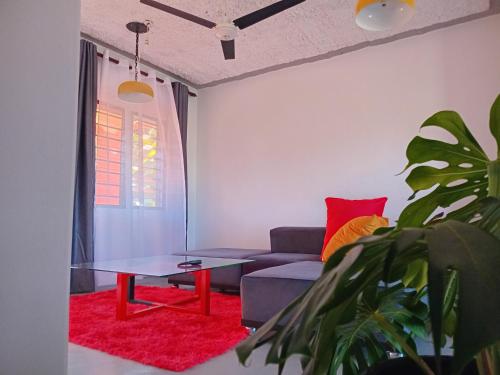 a living room with a couch and a table at Truenorth Apartments siem in Ukunda