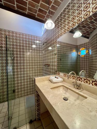 a bathroom with a sink and a shower at Mama Chuy Hotel & Villas Ajijic in San Juan Cosalá