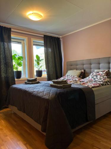 a bedroom with a large bed in front of a window at Close to Gothenburg & the sea - with your own sauna! in Billdal