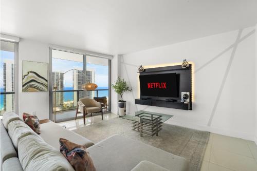 a living room with a couch and a tv at BeachWalk Resort - VIP TOWER - OCEANVIEW UNIT 3 BEDROOM & 3 BATHROOM in Hallandale Beach