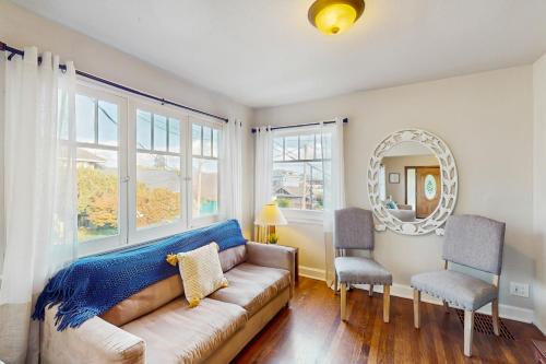 a living room with a couch and two chairs at The Jul on State in Bremerton