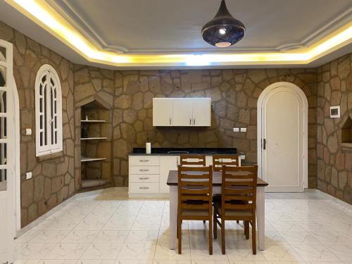 a kitchen with a table and chairs in a room at Luxor Nile Palace in Luxor