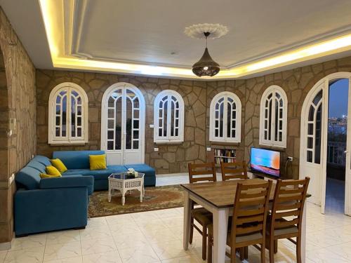 a living room with a blue couch and a table at Luxor Nile Palace in Luxor