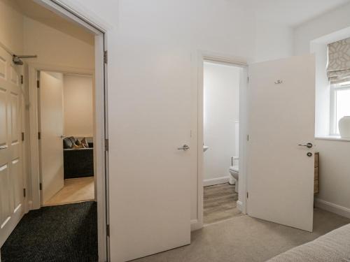 a bedroom with a door leading to a bathroom at Ullswater in Ulverston