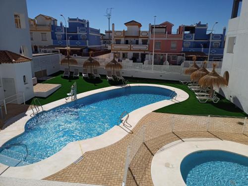 a large swimming pool in the middle of a building at Pegaso II in San Juan de los Terreros