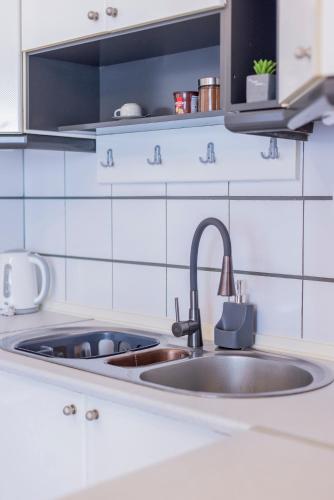 a kitchen counter with a sink in a kitchen at Trikala Homey Vibes in Tríkala