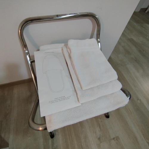 a pile of towels sitting on a towel rack at Town Center Apartment in Cagliari