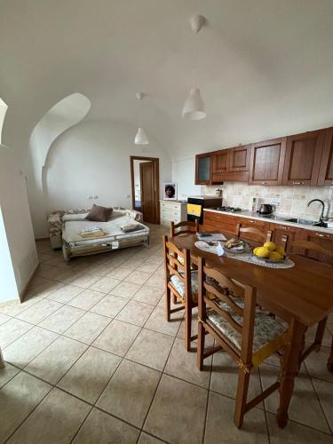 a kitchen with a table and chairs and a bed at A Casa di Ilary in Ravello
