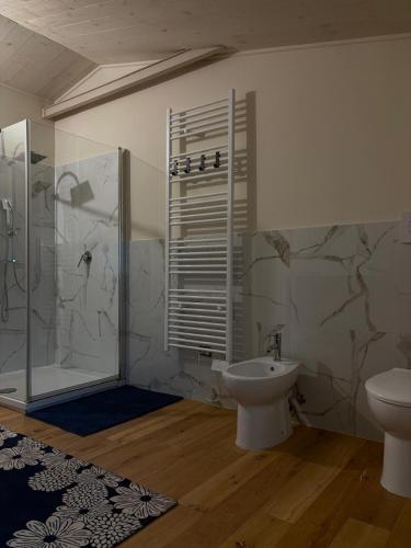 a bathroom with a shower and a toilet and a sink at Sangida Home in Lamezia Terme