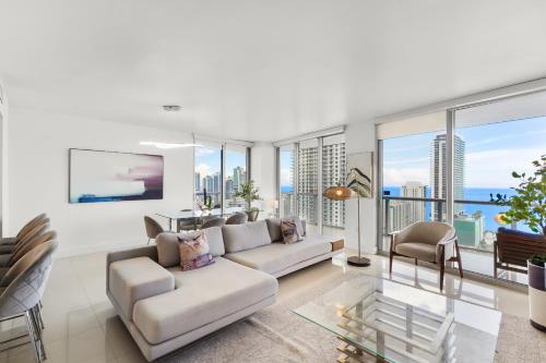 a living room with a couch and chairs and windows at BeachWalk Resort - VIP TOWER - OCEANVIEW UNIT 3 BEDROOM & 3 BATHROOM in Hallandale Beach