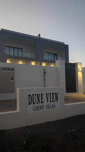a building with a sign that reads dume view luxury villas at Dune View Luxury Villas in Ḩawīyah