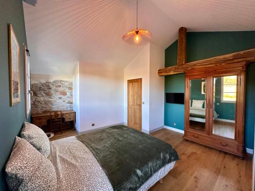 a bedroom with a large bed and green walls at Ferme Ihartzetako in Ascain